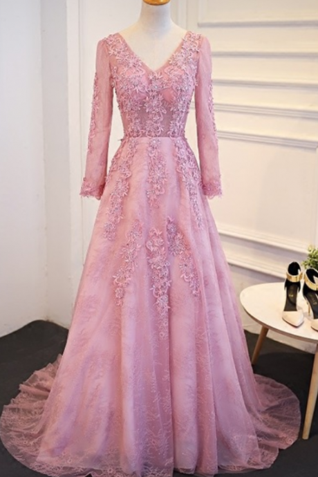 A Pink Lace Long-sleeved Evening Gown With Long, Curly Women Gathered In The Only Formal Evening Gown In The Trade